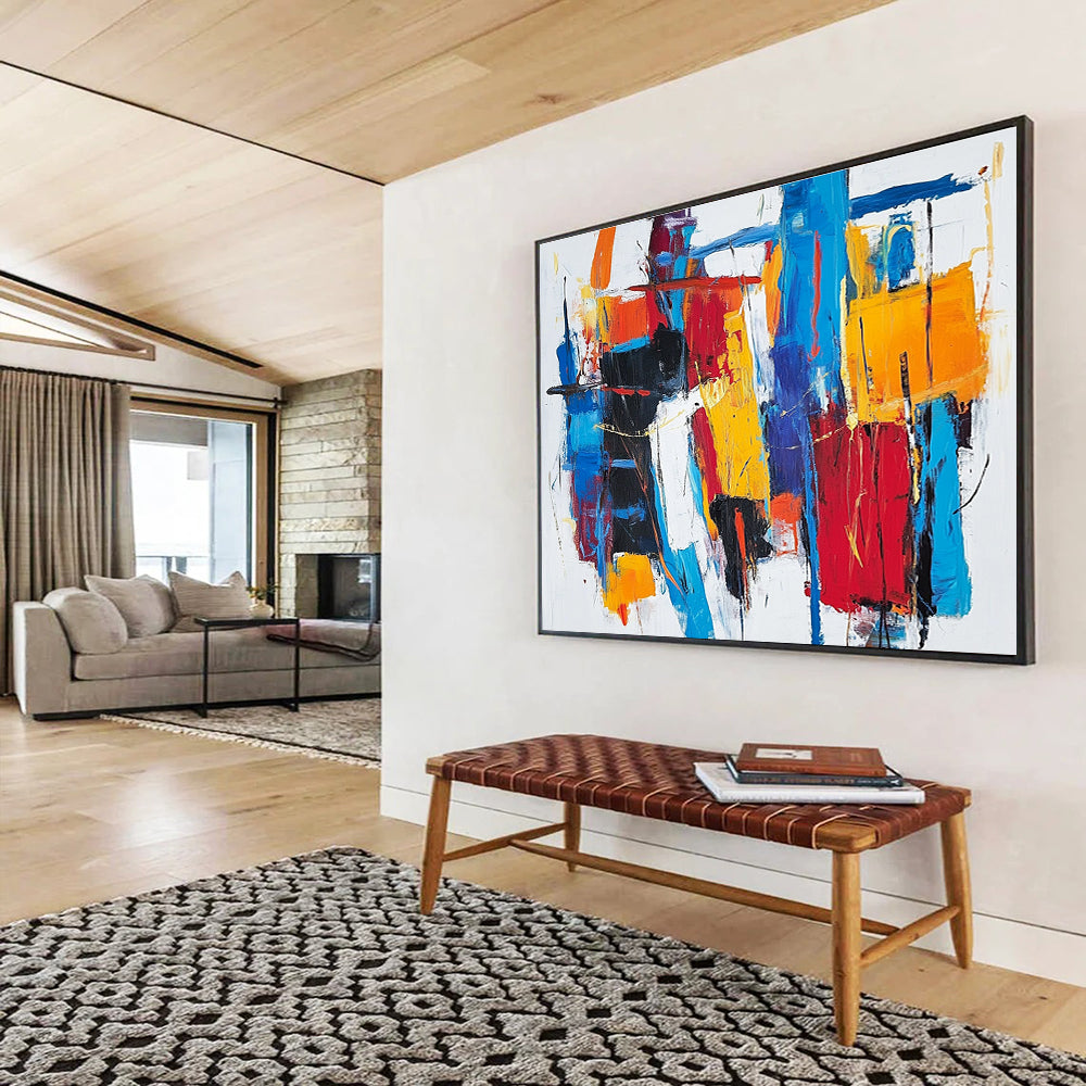 Large abstract painting with thick brush strokes and vibrant reds blues and yellows creating a unique abstract cityscape on a white background.SC262