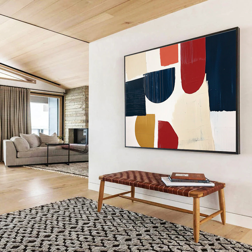 A large abstract painting featuring navy blue cream and red shapes with loose brush strokes on a white background in a collage style.SC489