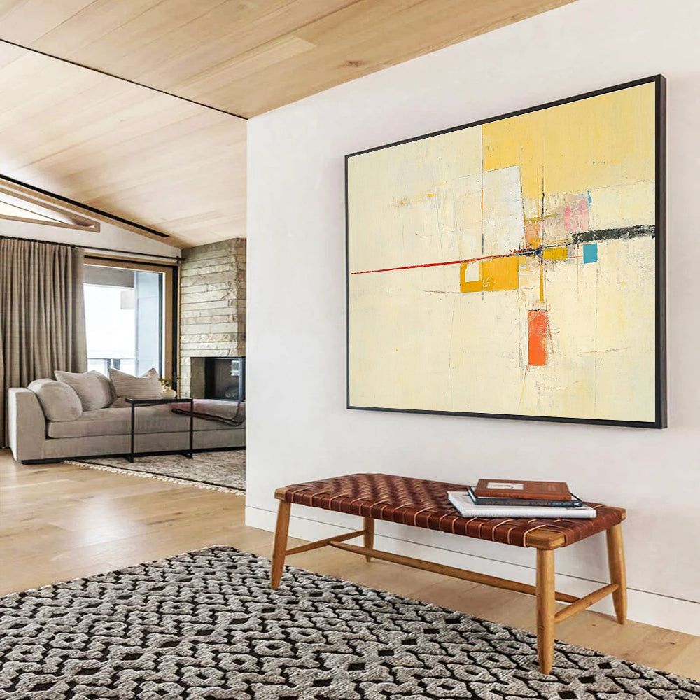 Large abstract painting featuring yellow beige colors thin red line off-white background small blue square soft orange lines geometric shapes and ample white space.SC332