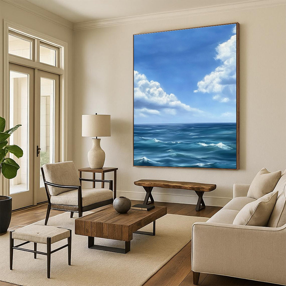 Large abstract painting depicting a tranquil ocean scene with gentle waves under a vast blue sky and soft white clouds in Monet's style.STSC1215