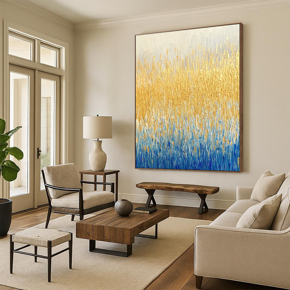Large abstract painting of a textured wheat field in gold and blue hues showcasing fine art style and neutral tones.STSC291
