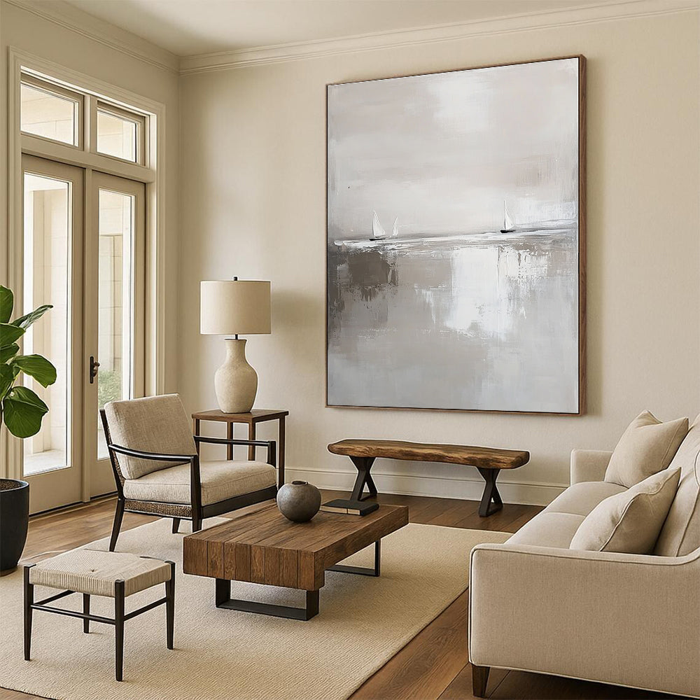 Large abstract painting in white and gray featuring calm waters and distant sailboats in a minimalist style with neutral tones.STSC359