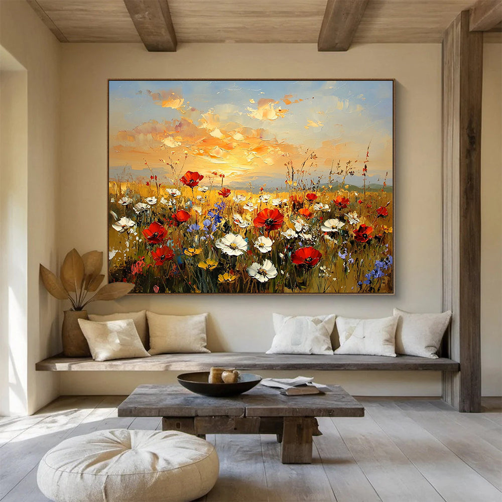 Large abstract painting of a wildflower field at sunset featuring red poppies white daisies and yellow sunflowers in vibrant hues of orange and blue.SC464