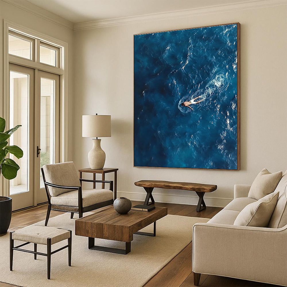 Large abstract painting depicting a solitary man in deep blue ocean waves wearing white swim trunks evoking solitude and calmness amidst chaos.STSC1057