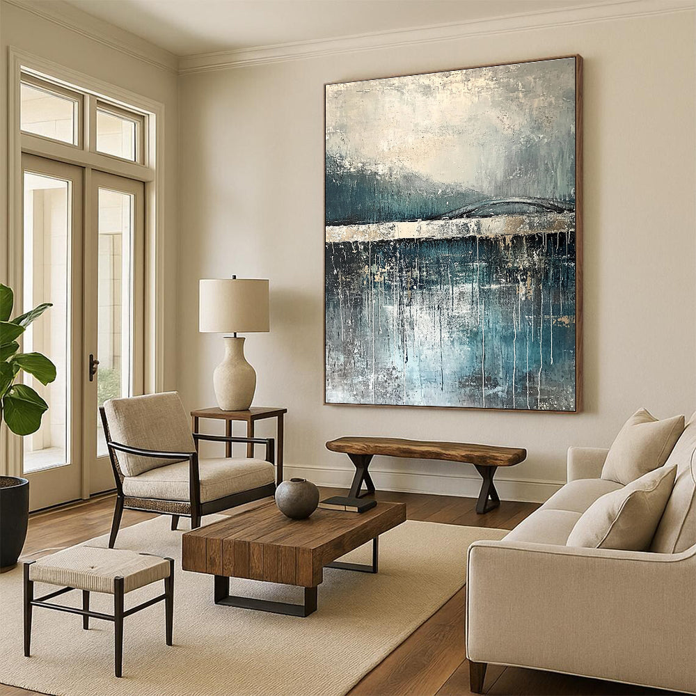 Large abstract painting depicting rain reflections on water with an old bridge in gray and blue tones accented with silver on textured canvas.STSC326