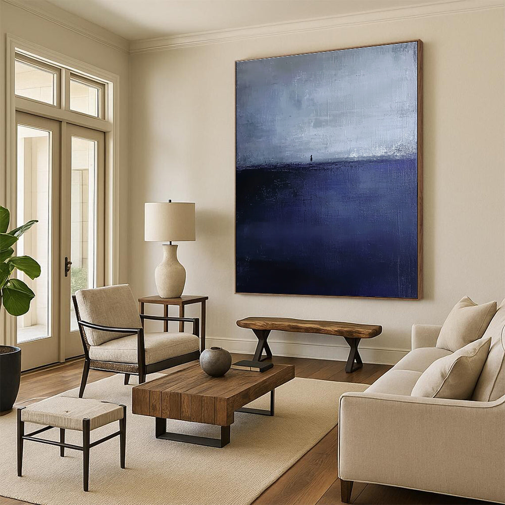 Large abstract painting in dark blue and gray depicting an atmospheric seascape with a small silhouette on the distant horizon.STSC1085