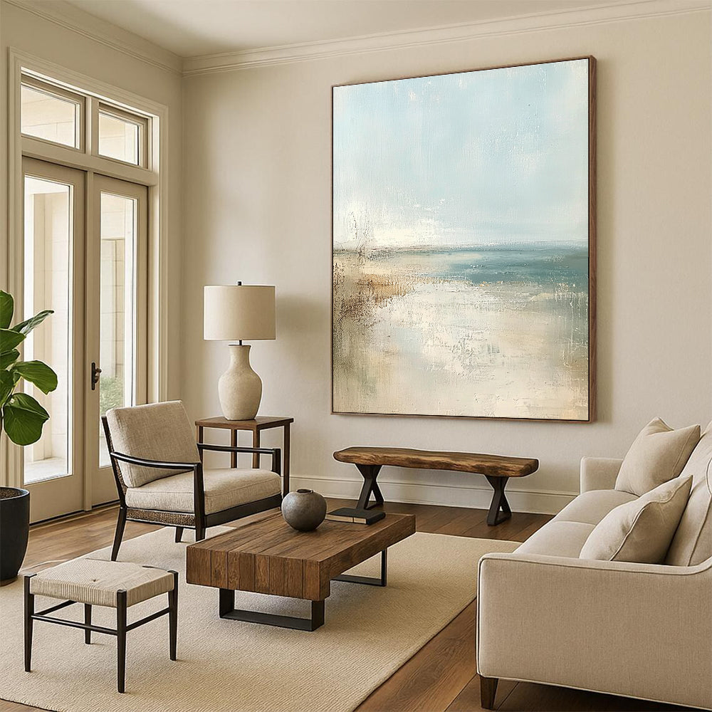 Large abstract painting of a beach in soft pastel colors featuring a light blue sky and neutral tones for a serene atmosphere.STSC158