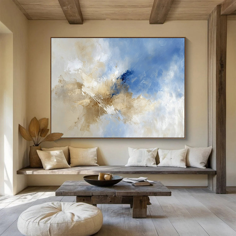 Large abstract painting featuring blue and beige hues with clouds in the sky, blending earthy tones of brown for a serene atmosphere.SC020