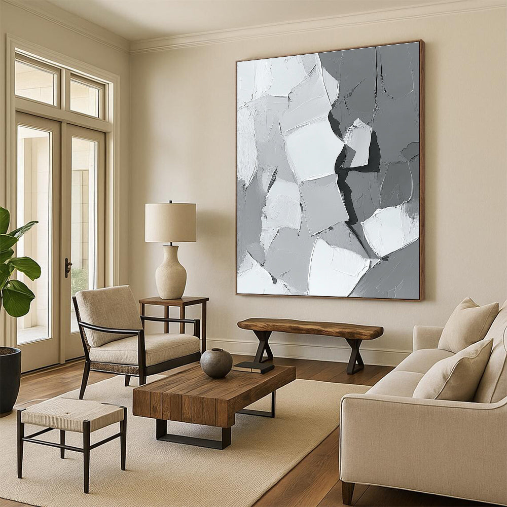 Large abstract painting in gray and white showcasing body parts in armor with bold brush strokes and thick paint application in a striking monochrome palette.STSC479
