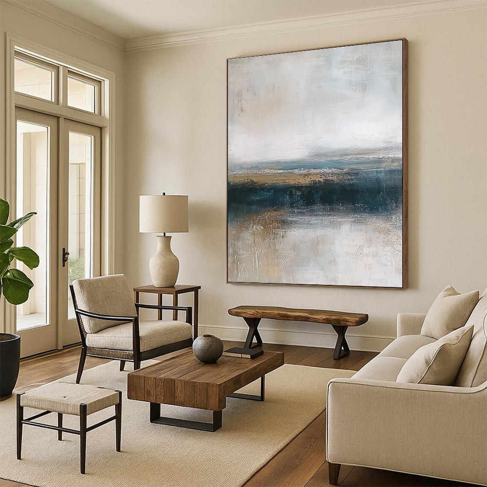 Large abstract painting depicting textured ocean waves in blue and gray with a soft beige sky and earthy shore tones for a tranquil ambiance.STSC463