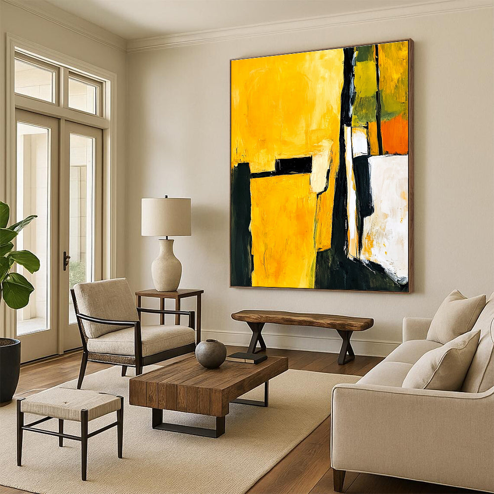 Abstract painting in yellow and black featuring white shapes with a minimalist atmosphere and an armchair in the foreground.STSC718