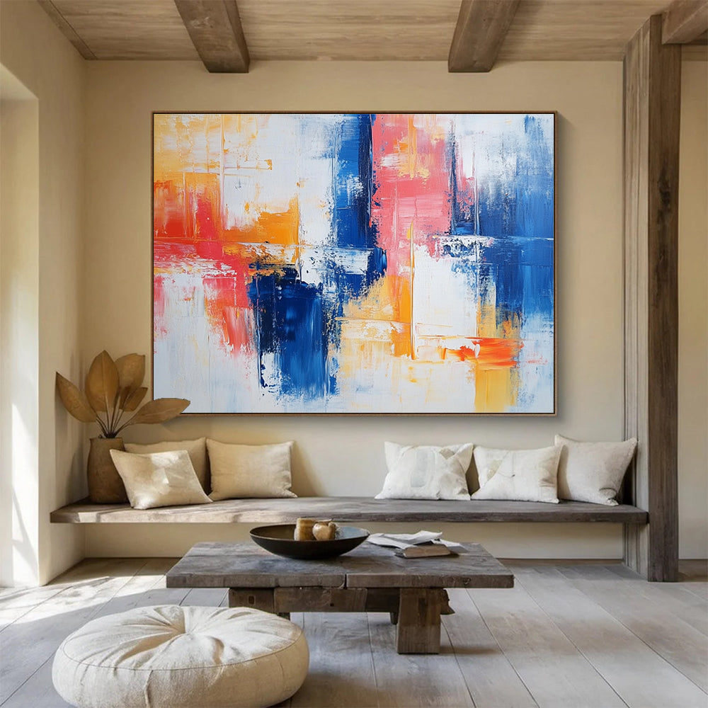 Large abstract painting with vibrant blue and red brush strokes on white, featuring yellow highlights and textured layers that evoke nostalgia and joy.SC263