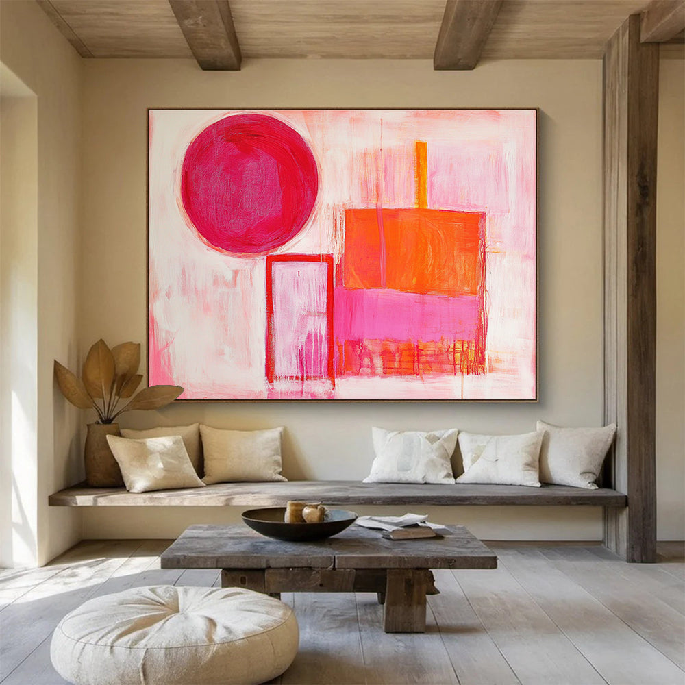 The large abstract painting features thick brush strokes with warm pink and orange hues, showcasing a circle, square, and rectangular shape.SC540