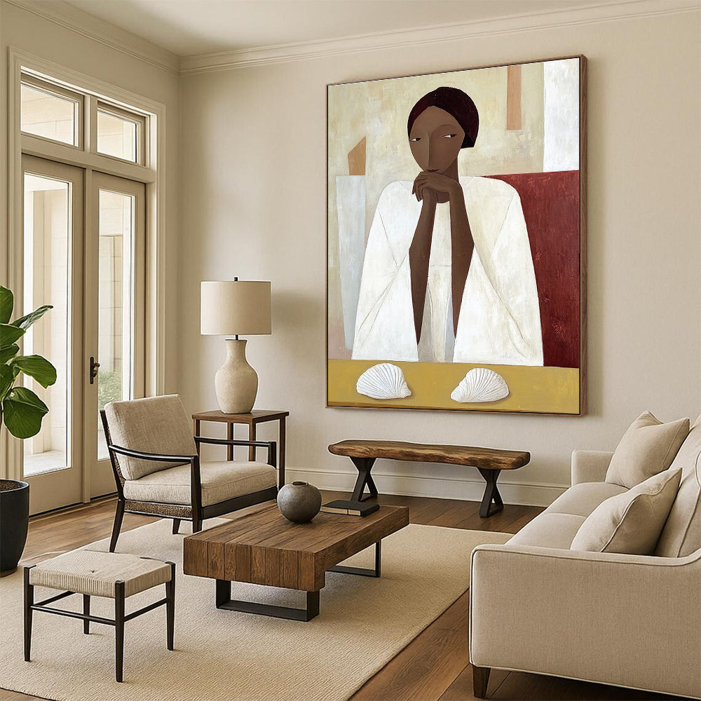 A large abstract painting featuring an African woman in a white cloak sitting on a yellow table with shells in daylight.STSC1115