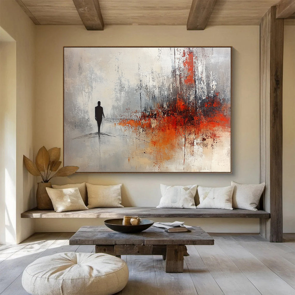 Large abstract painting in soft gray and white tones with red and orange splashes featuring a silhouette in an ominous landscape.SC258
