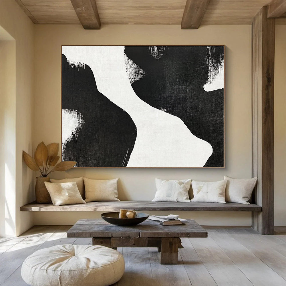 Large abstract painting featuring black and white brush strokes depicting two women’s bodies against a plain white background, showcasing minimalist artistry and tranquil form.SC439