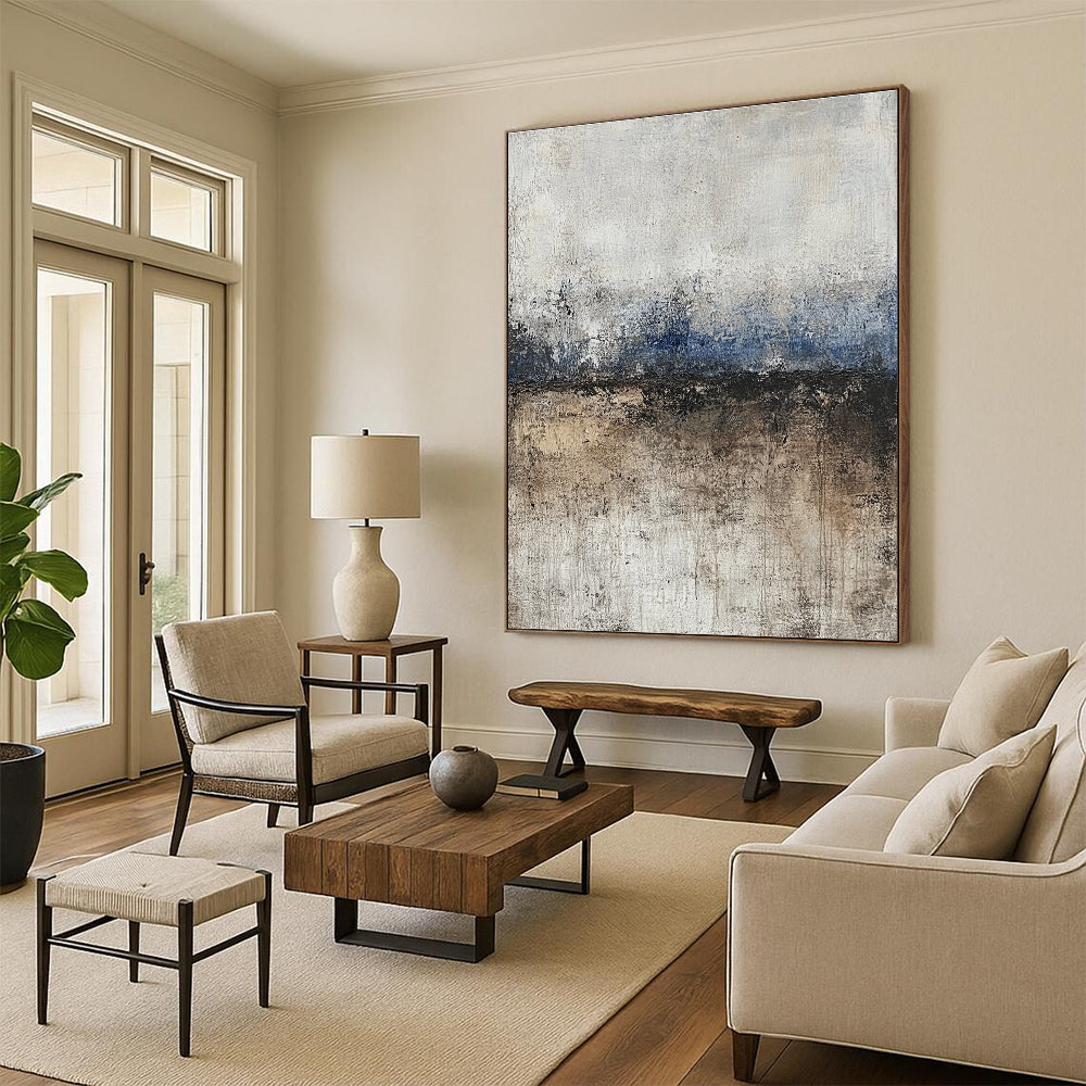 Large abstract painting featuring soft edges and subtle color transitions of beige blue-gray and brown with a path leading to tranquil water.STSC125