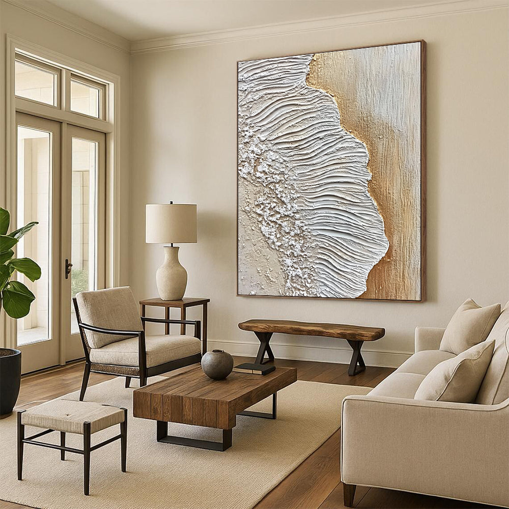 A large abstract painting featuring textured sand and waves in white and beige against an oak wood floor, embodying coastal elegance.STSC946