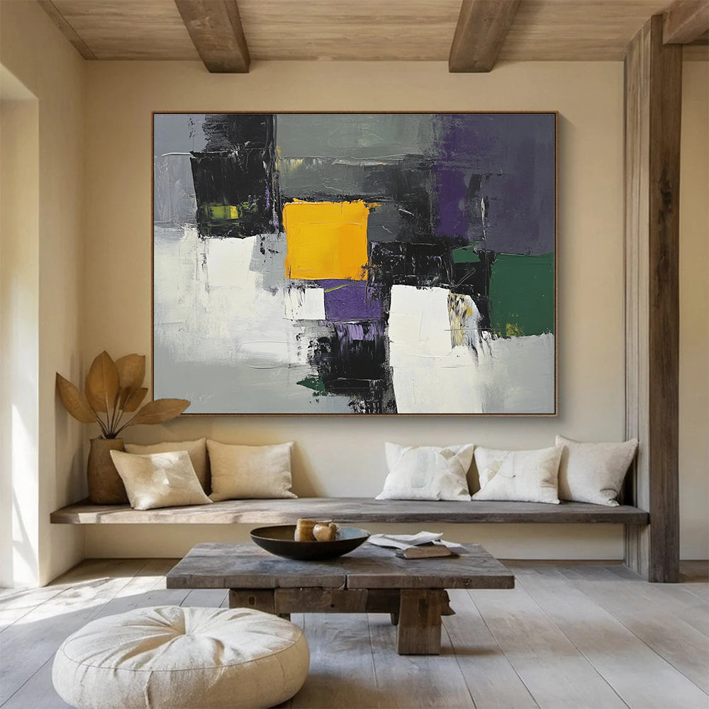 This large abstract painting features gray white and purple shapes with a central yellow square and green and olive accents using thick brush strokes.SC324