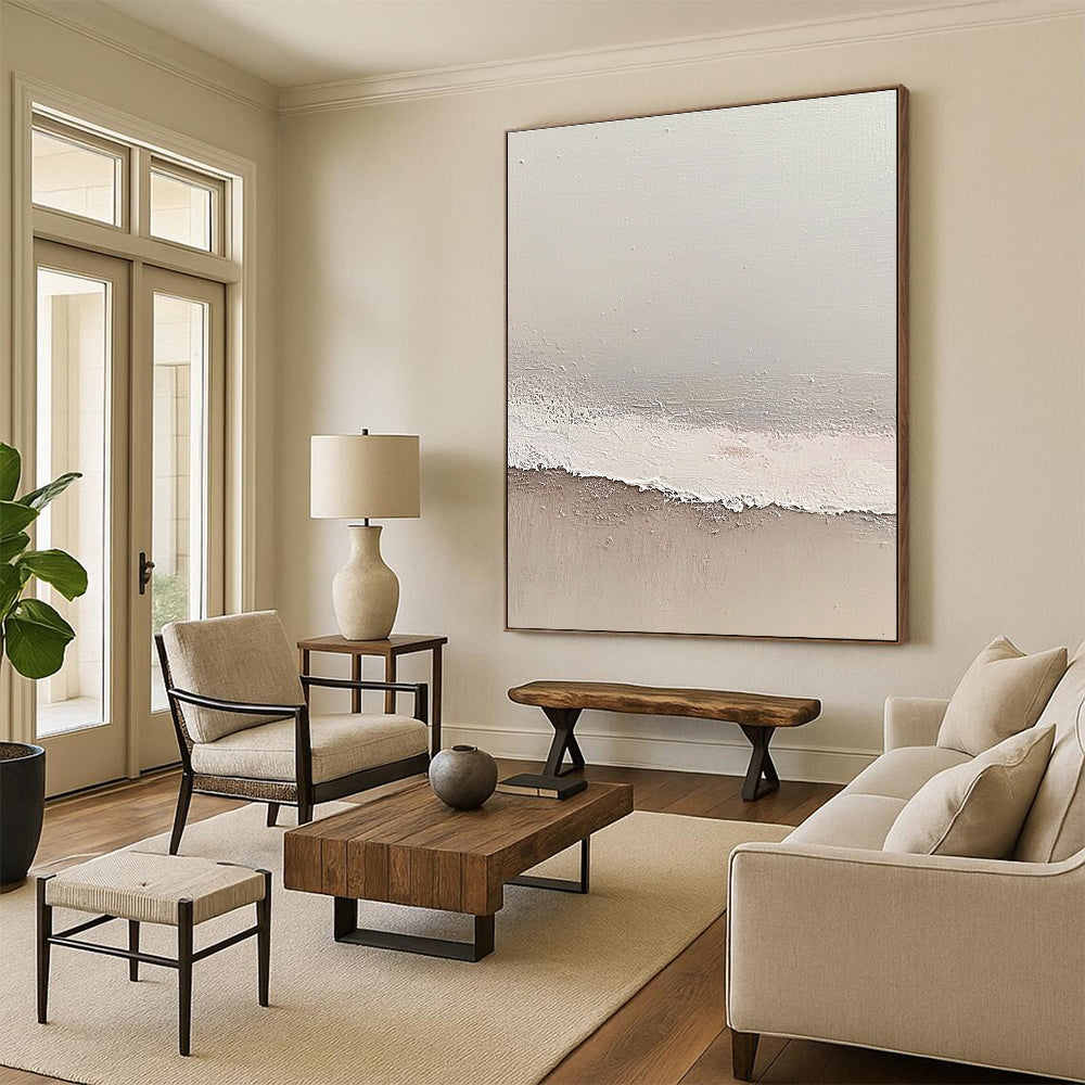 Large abstract painting depicting a serene beach scene with soft gray and pale pink tones featuring gentle waves and textured surfaces.STSC1427