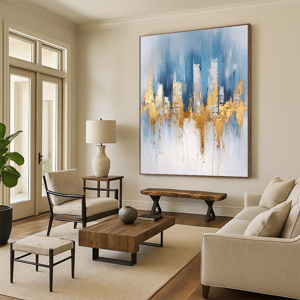 Large abstract blue and gold painting with urban landscape details light gray brushstrokes and elegant gold foil accents on canvas edges.STSC033