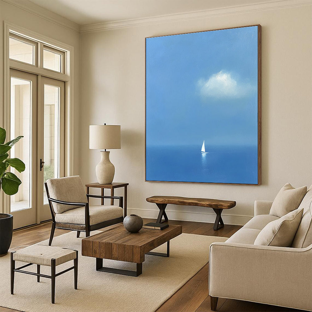Large abstract painting featuring a white sailboat on the sea in light blue and indigo colors creating a dreamy atmosphere with ethereal clouds.STSC1255