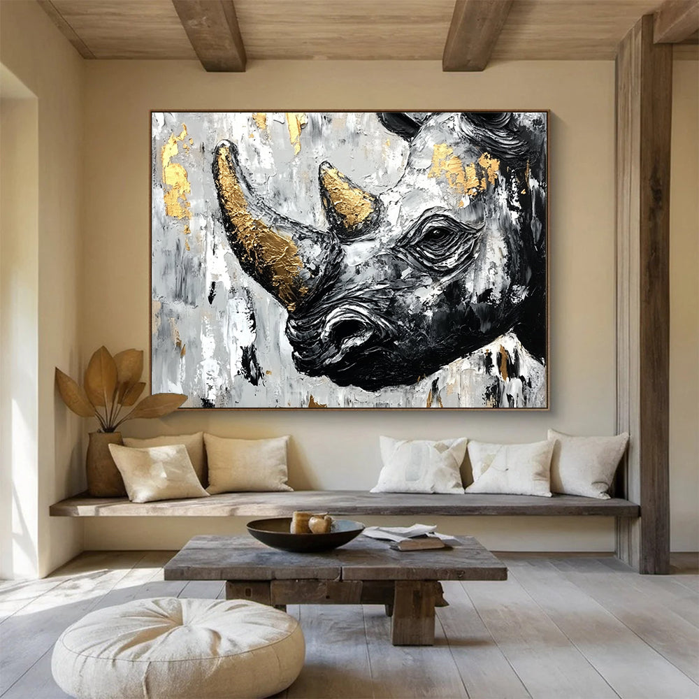 Abstract painting of an African rhinoceros in black and white with gold accents and textured strokes on a neutral background.SC151