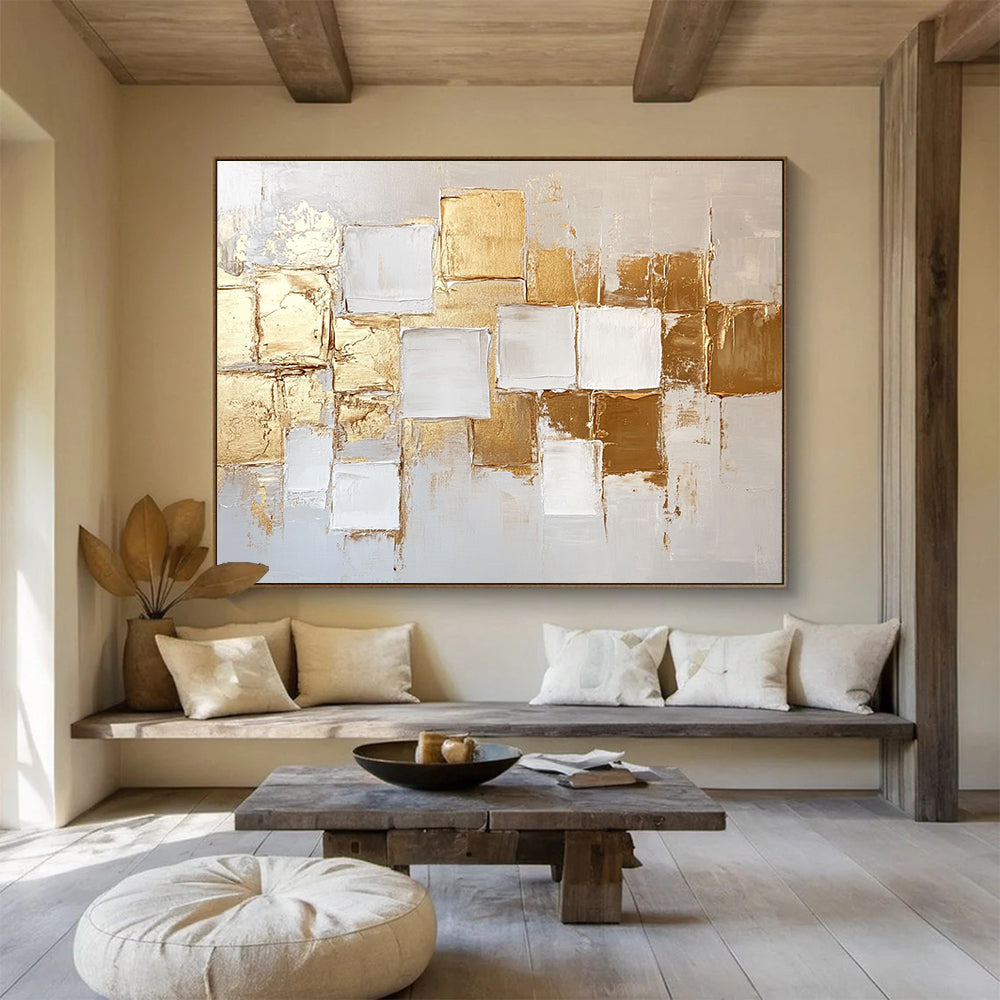 Large abstract painting in white and gold featuring textured square block patterns and soft lighting for an elegant touch.SC292
