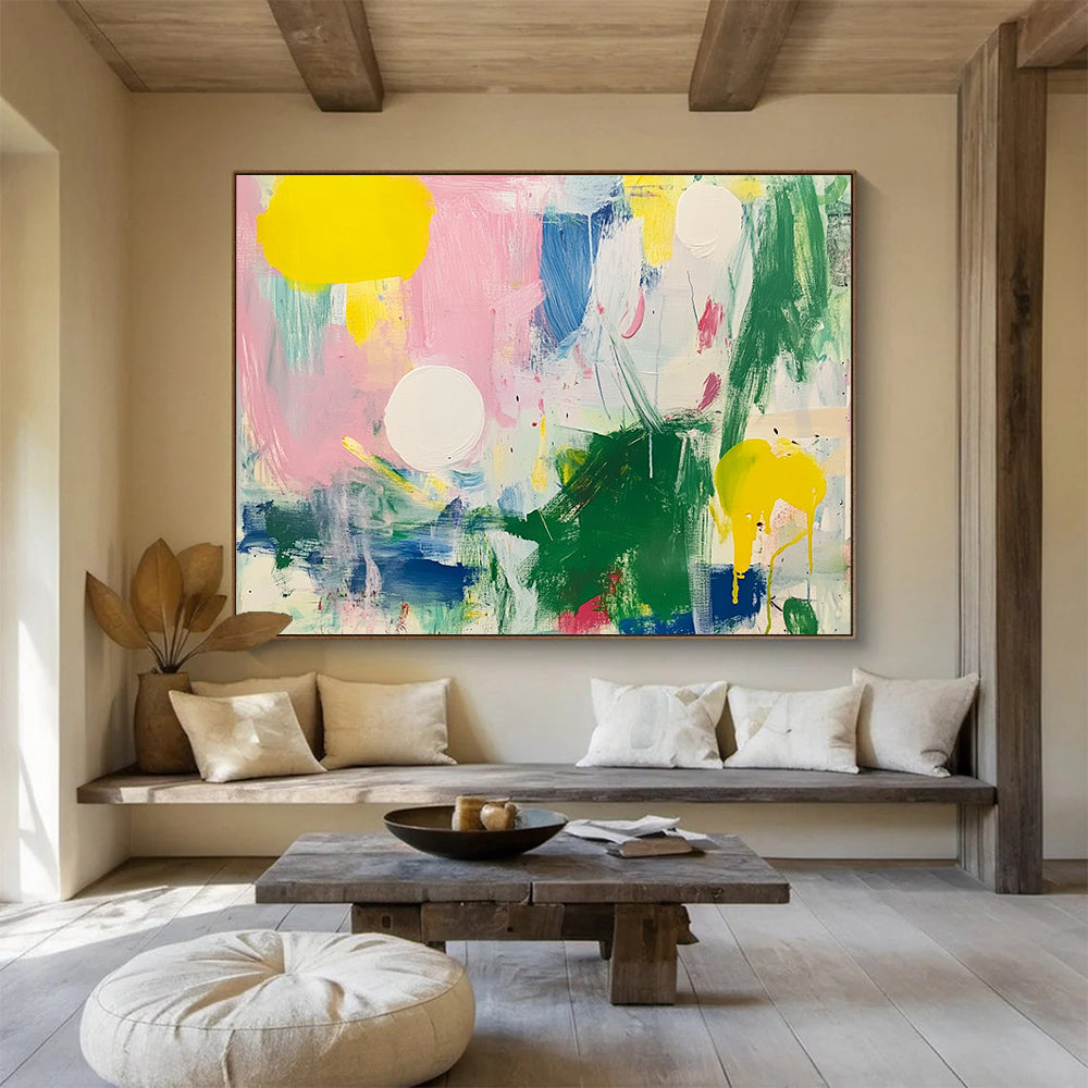 Large abstract painting featuring bright colors with green and pink shapes white circles yellow lines blue lines and light red elements on a white background.SC231