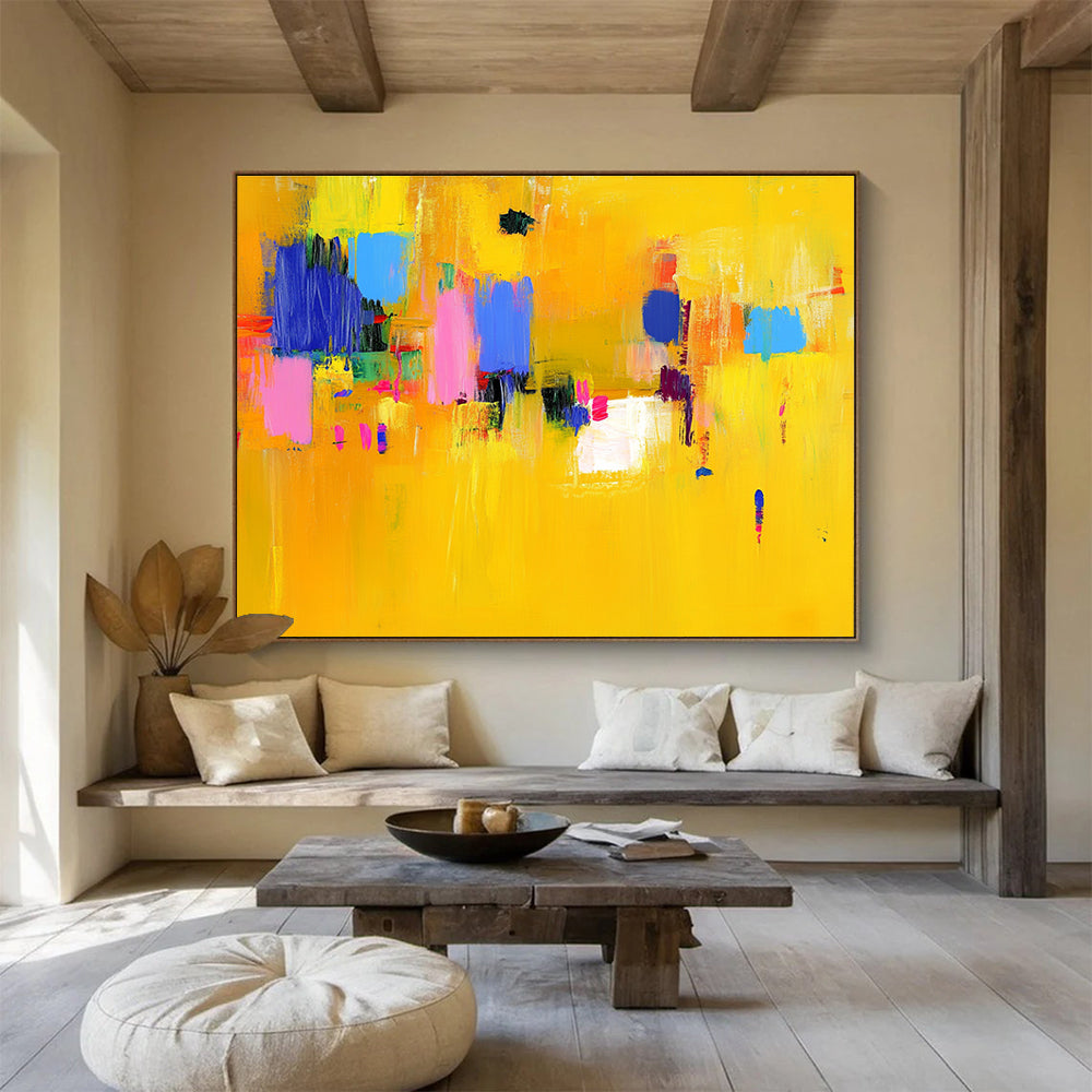 Large abstract painting featuring bold yellow and blue strokes with pink accents dynamic lines and vibrant textures creating an energetic atmosphere.SC147