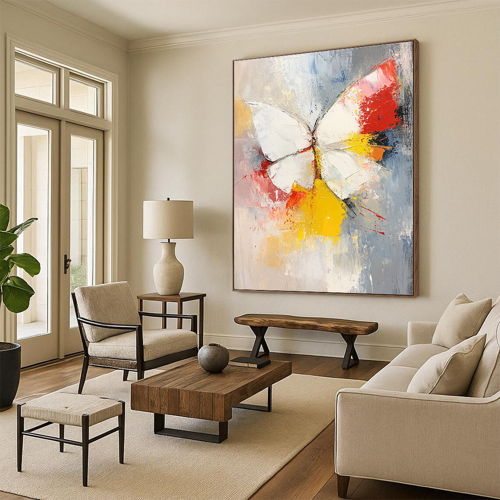 Large abstract painting featuring a white and red butterfly with vibrant yellow feathers set against a soft gray and pink background.STSC552