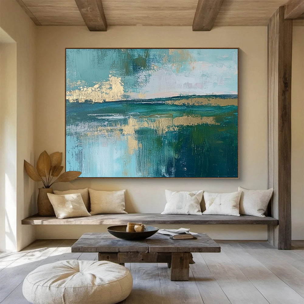 Large abstract painting featuring a serene lake, vibrant green fields, light blue sky, and elegant gold foil accents.SC115