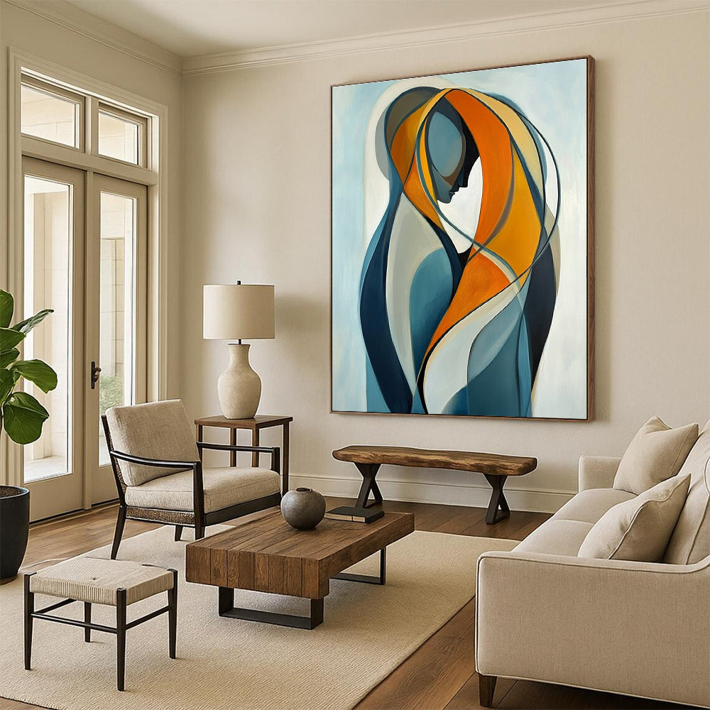 Large abstract painting of two intertwined figures in vibrant orange and yellow against a light blue background emphasizing connection and softness.STSC1143