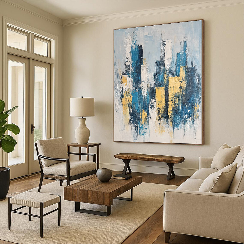 Large abstract painting featuring a modern cityscape in neutral blue and gray tones with yellow accents inspired by impressionist style.STSC1358
