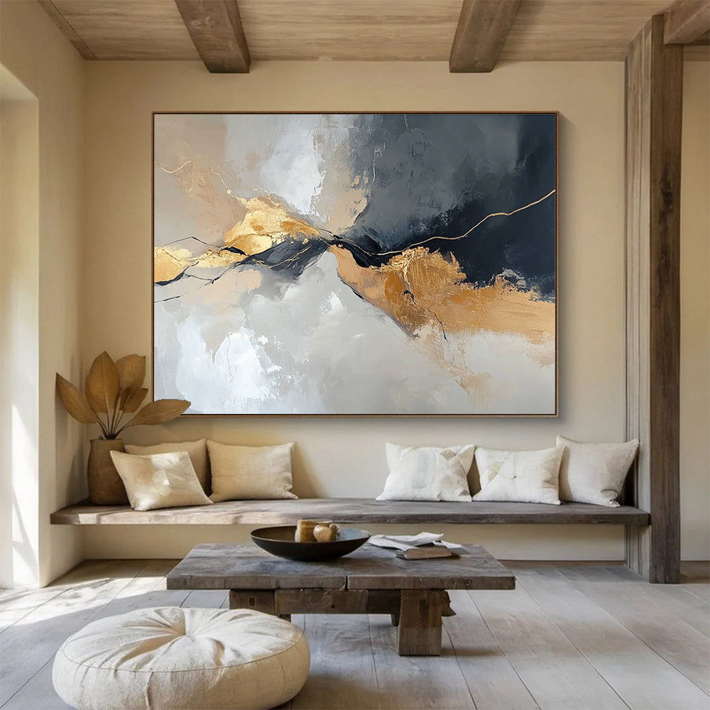 Large abstract painting with an aerial view in gray and beige colors featuring minimalistic shapes and brush strokes enhanced with gold accents.SC104