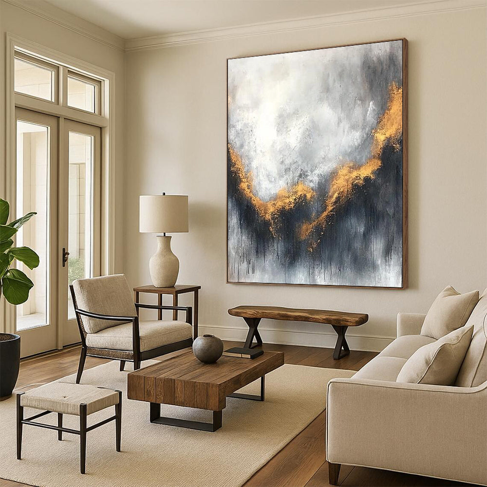 Large abstract painting with gray and white background golden accents atmospheric clouds and soft edges evokes calmness and introspection.STSC397