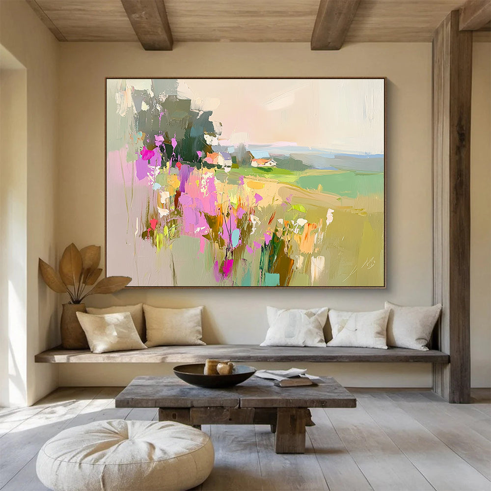 Large abstract painting featuring a floral landscape with fields and a distant cottage in soothing pink purple green and blue tones.SC110