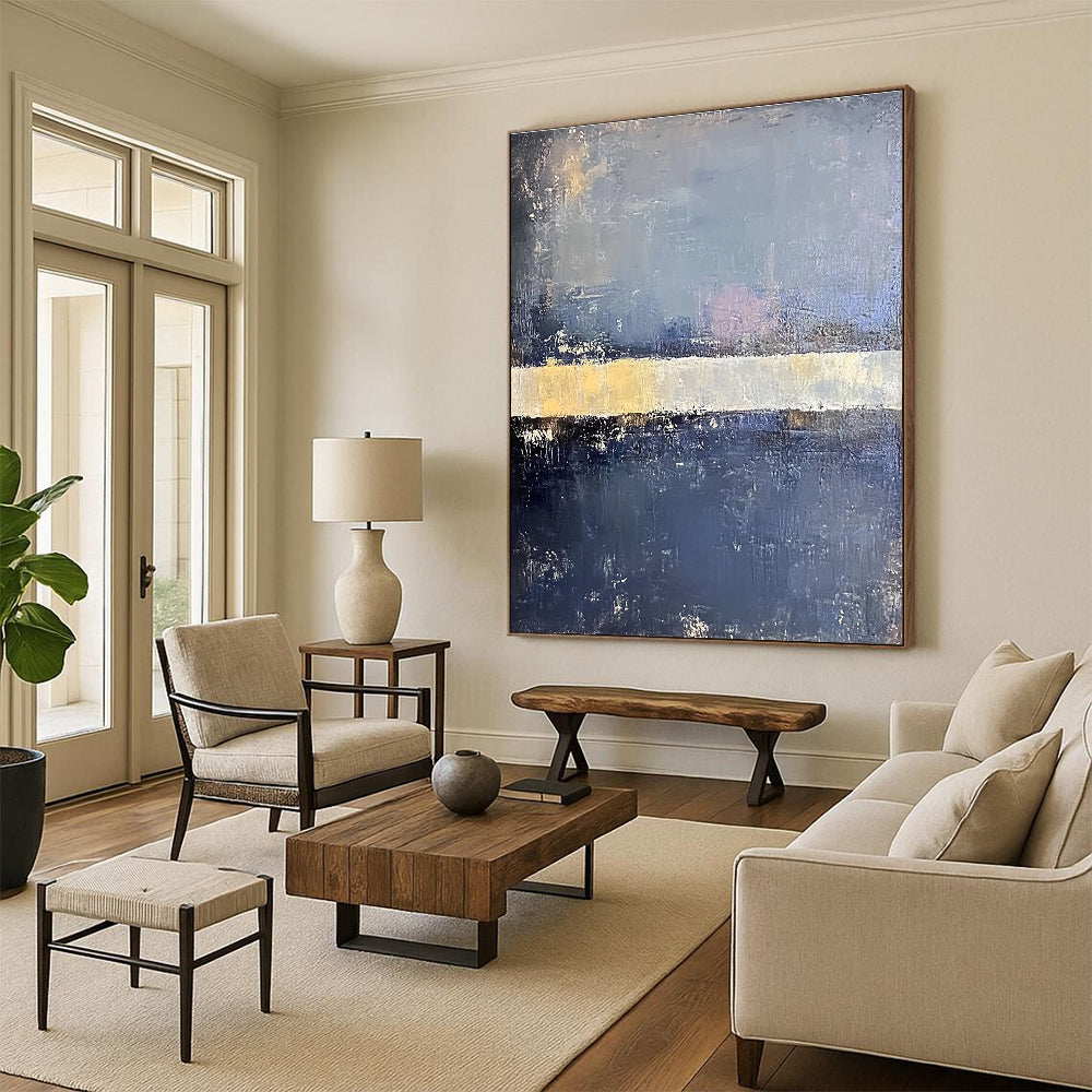 Large abstract painting in faded hues of blue gray and pale yellow with soft edges on a dark gray background featuring a white bar.STSC218