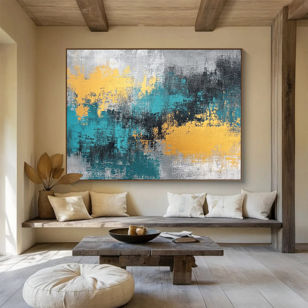 Large abstract painting featuring teal, grey, and gold hues that add a vibrant touch to any space.SC260
