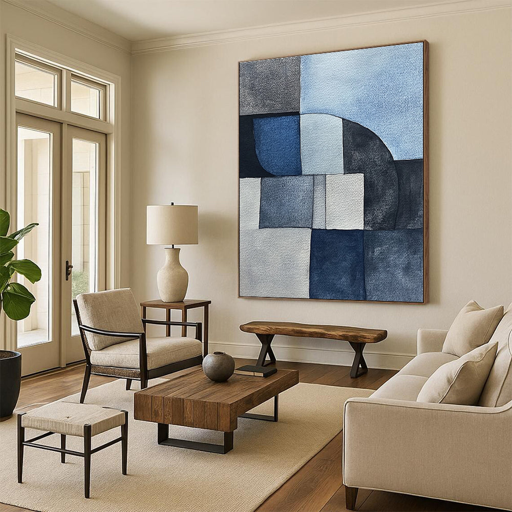 Large abstract painting features minimalistic gray-blue watercolor cubist shapes depicting sandstone rocks in a serene desert landscape.STSC240