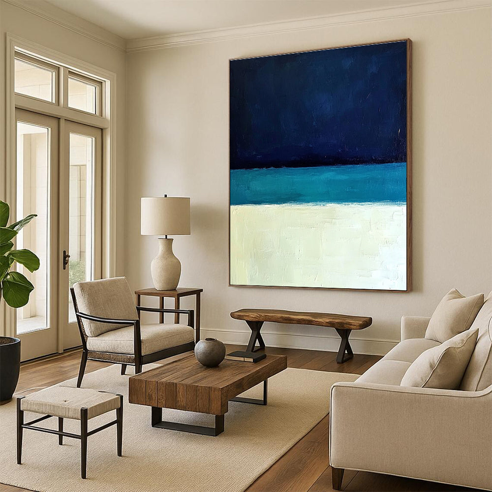 Large abstract painting featuring a minimalist ocean scene with blue tones white sand beach and a dark sky in Rothko style.STSC884