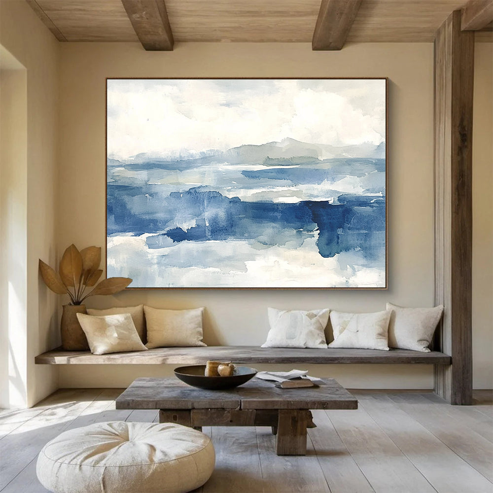 Large abstract painting of the sea features shades of blue and gray with soft clouds, evoking a stormy atmosphere and depth.SC289