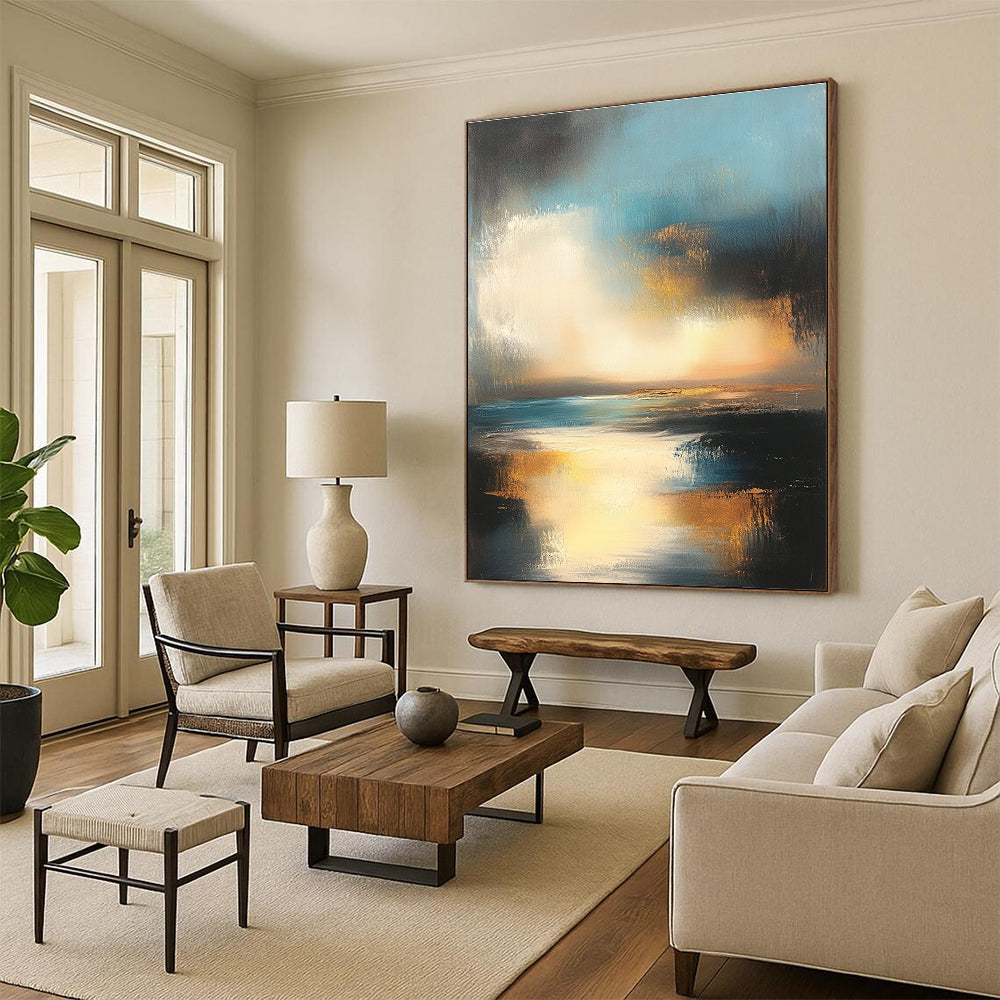 Large abstract oil painting depicting the ocean and sky at sunset with muted colors and gold accents for a serene ambiance.STSC196