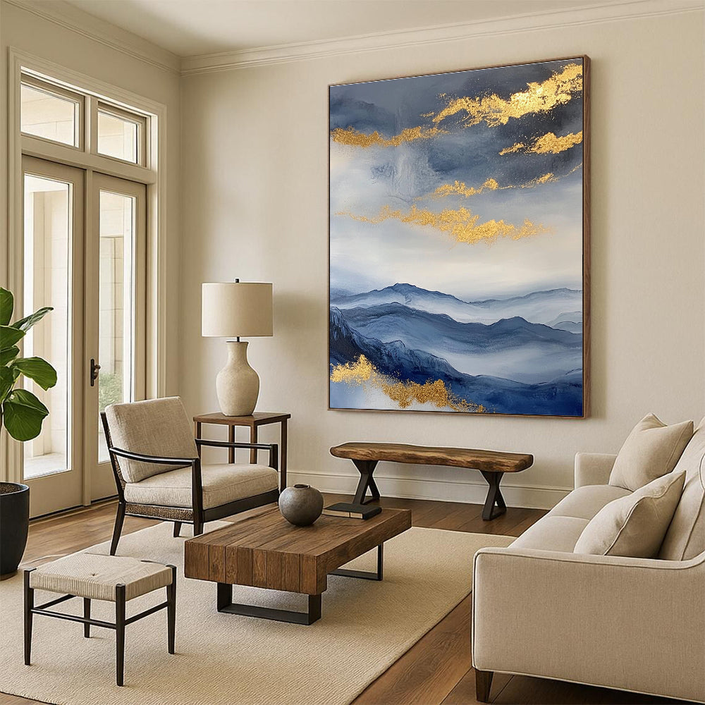 Large abstract painting featuring a beautiful sky mountains and clouds in blue and gray with gold foil accents.STSC279