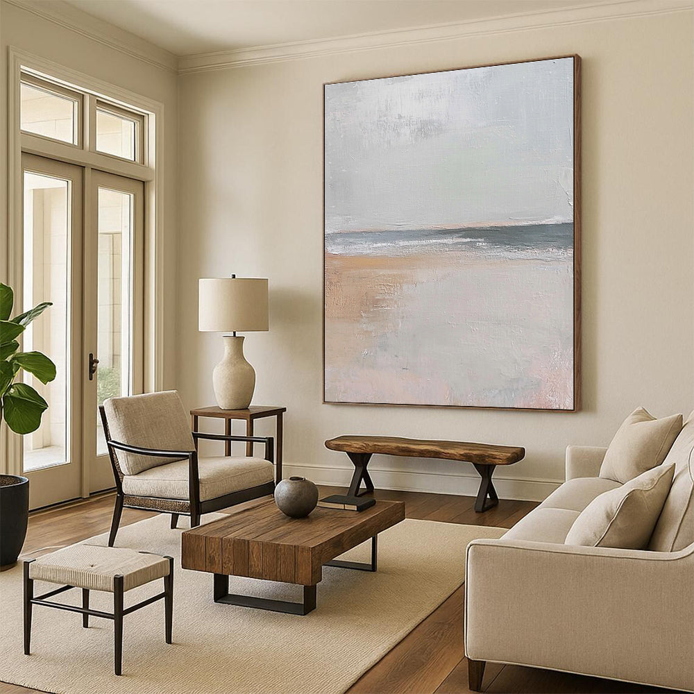 Large abstract painting in muted beige and gray tones featuring gentle brushstrokes of serene coastal scenery with hints of sandy textures and flying seagulls.STSC016