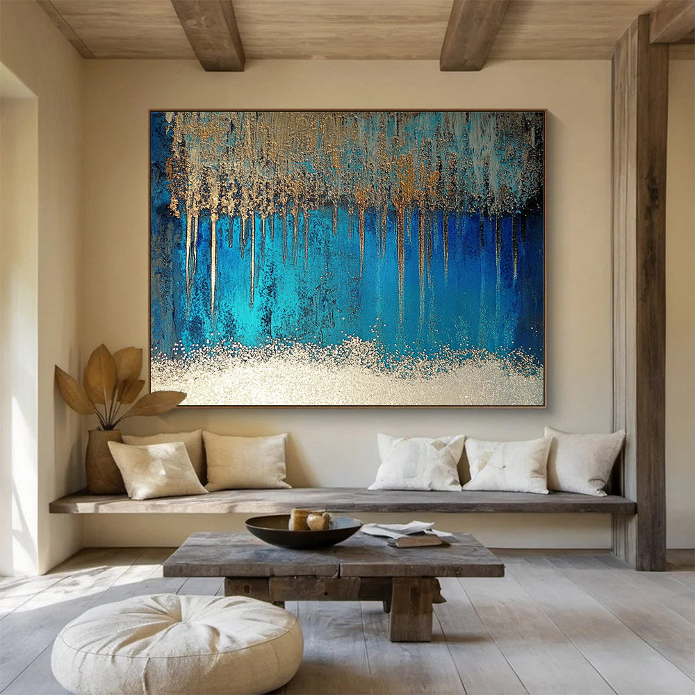 A large abstract painting featuring blue and silver patterns with glittering white sand and a rich brown liquid, accented by a thin silver line.SC346