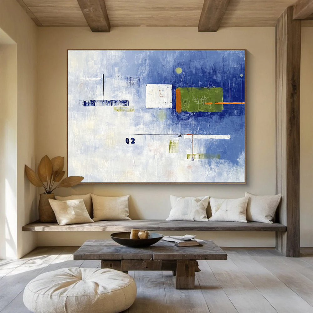 A large abstract painting with broad brush strokes in cool blue and white, featuring bold geometric shapes in green and orange, creating depth and contrast.SC493
