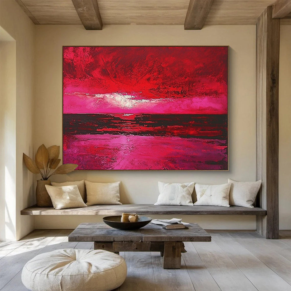 Large abstract painting depicting a red sky over the sea with hues of pink and crimson capturing the beauty of a sunset.SC273