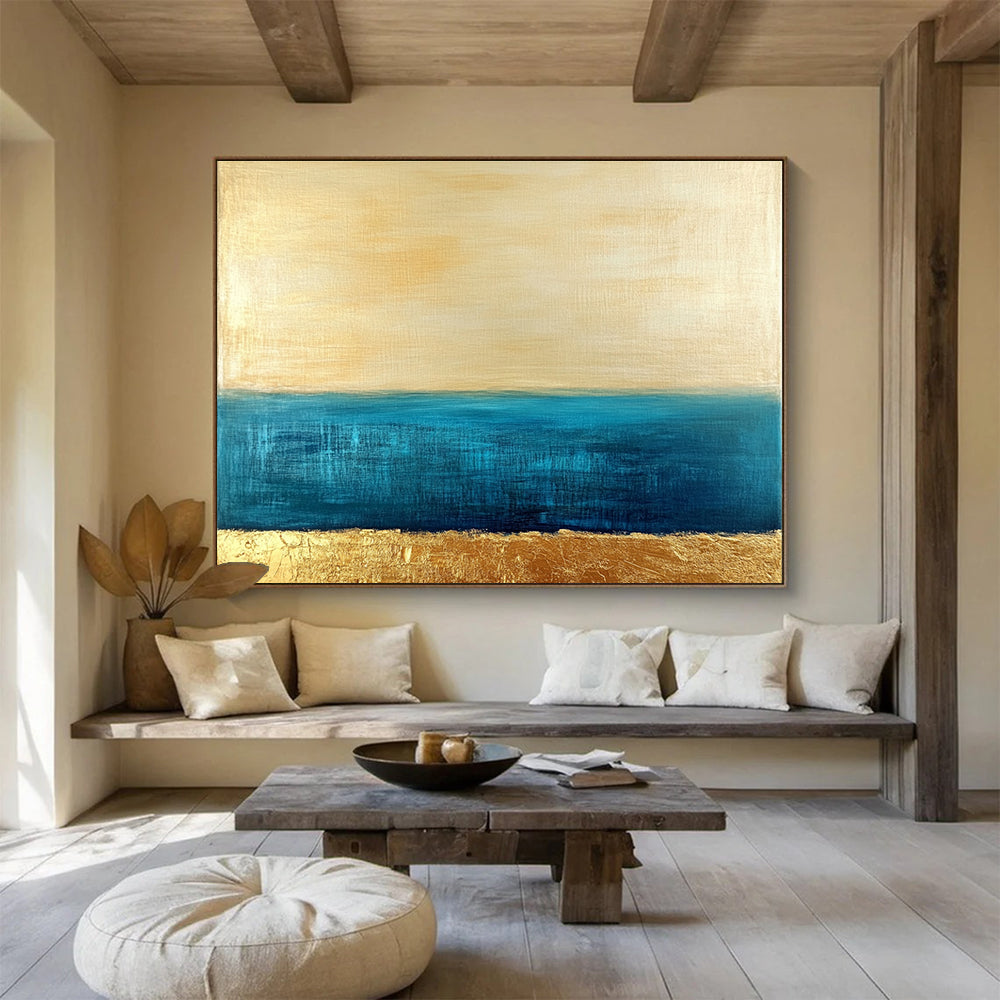 Large abstract painting featuring a golden sky and blue sea with textured gold accents and a soft minimalist aesthetic.SC172