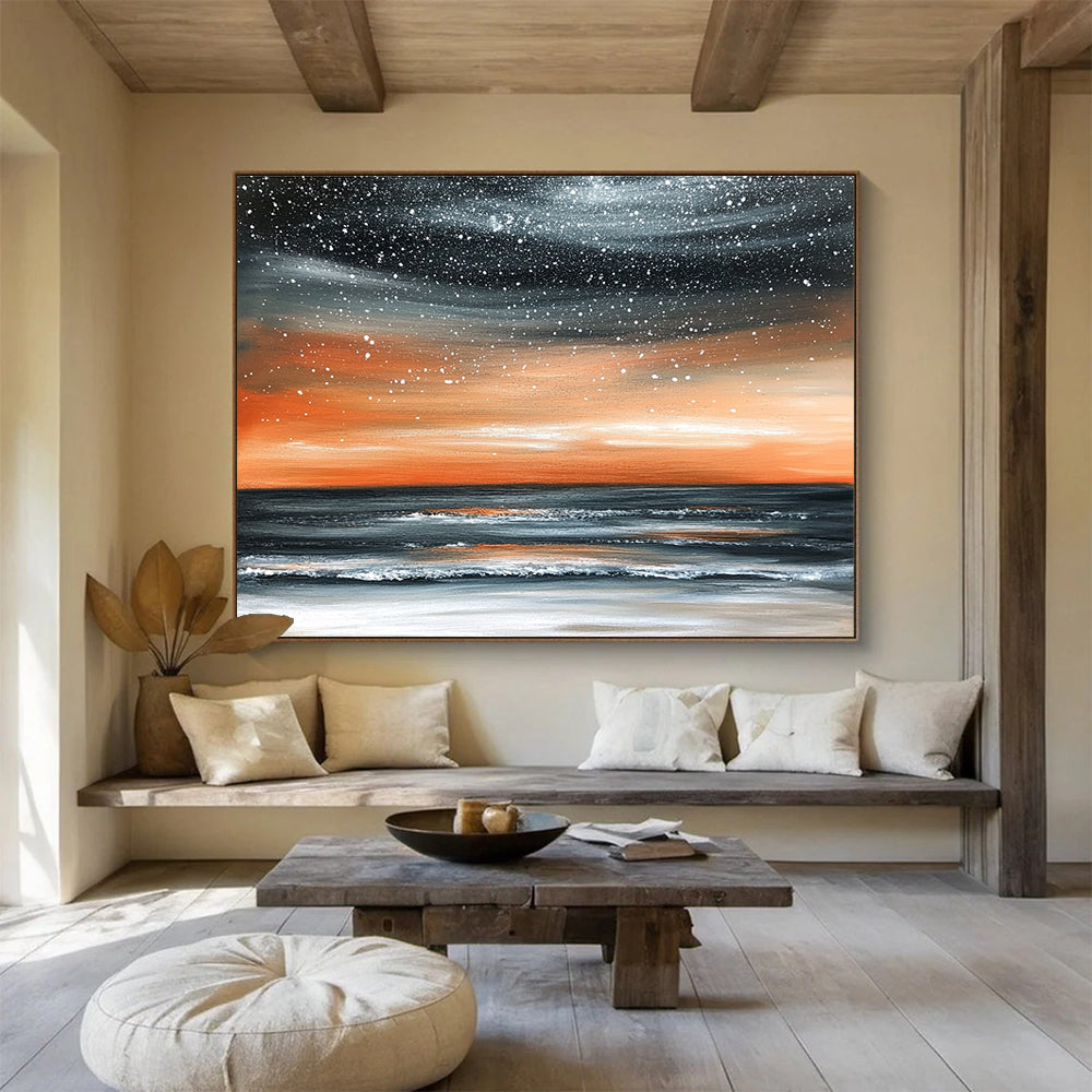 Large abstract painting of the ocean at night featuring an orange gray sky and starry snowfall over a muted water surface.SC130